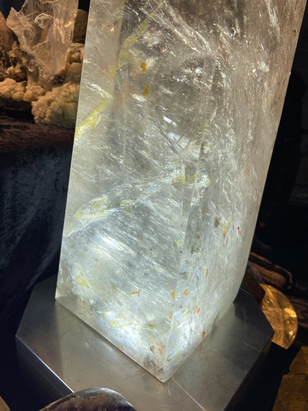 Rock crystal earth guardian crystal with many red, orange and yellow hematite inclusions