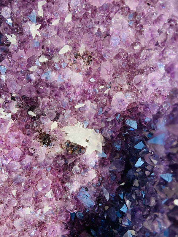 Large amethyst druse with many small calcite flowers and crystals