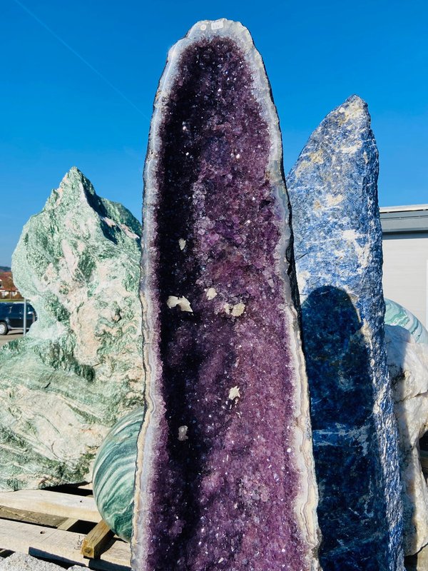 Large amethyst druse with many small calcite flowers and crystals