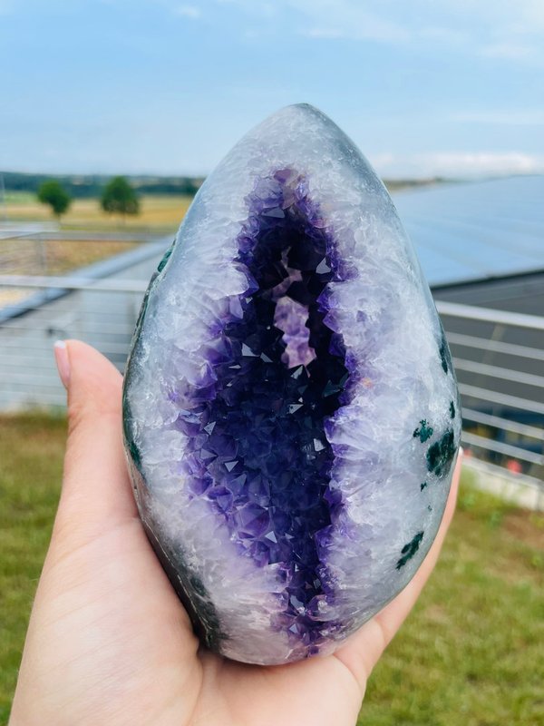 Very dark Uruguay amethyst druse with colorful agate flower in polished rim