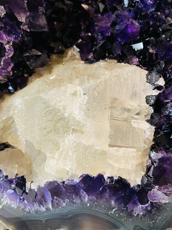 very dark Uruguay amethyst druse with large calcite and agate bloom